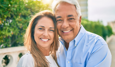 Man and woman smiling together on a sunny day