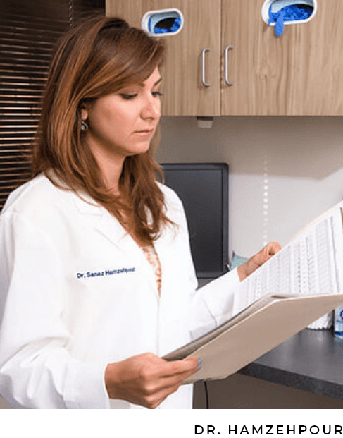 Dr. Hamzehpour looking at patient paperwork