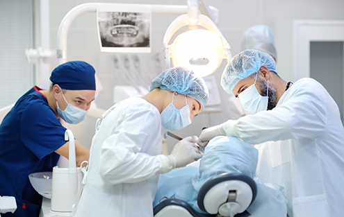 Dental team performing a dental procedure on a patient