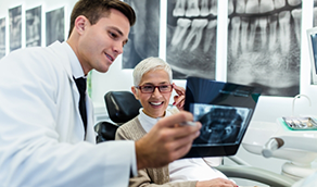 Dentist showing x rays to a patient