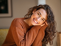 Portrait of smiling woman wearing cozy sweater