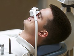 Man smiles while using nitrous oxide sedation in Torrance