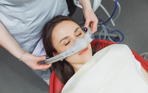 Dental patient with nitrous oxide mask over her nose