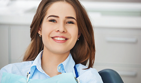 Brunette woman smiling in dental chair