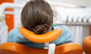 Person laying back in dental chair