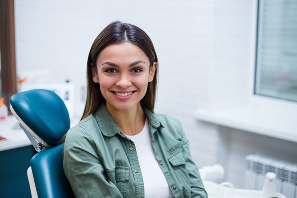 woman in dental chair, smiling