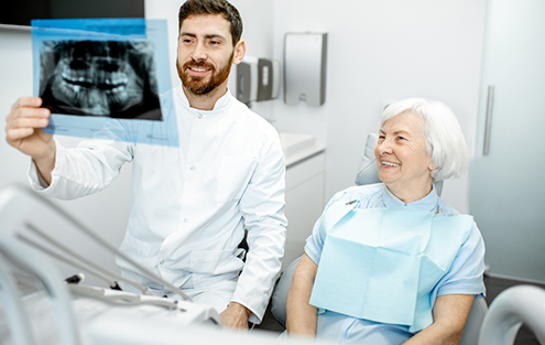Dentist showing a patient an x ray of their teeth
