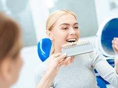 Dental patient admiring results of her smile makeover