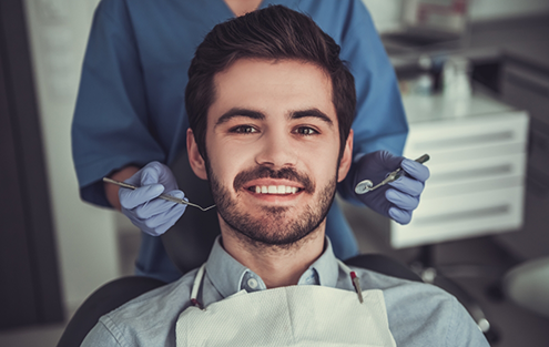 Young man smiling in dental chair
