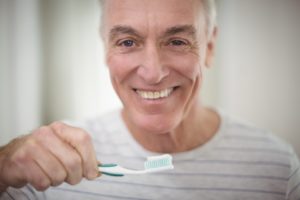 Senior man brushing teeth