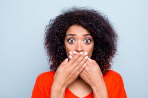 woman covering mouth with hand