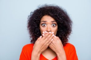 woman covering mouth with hand 