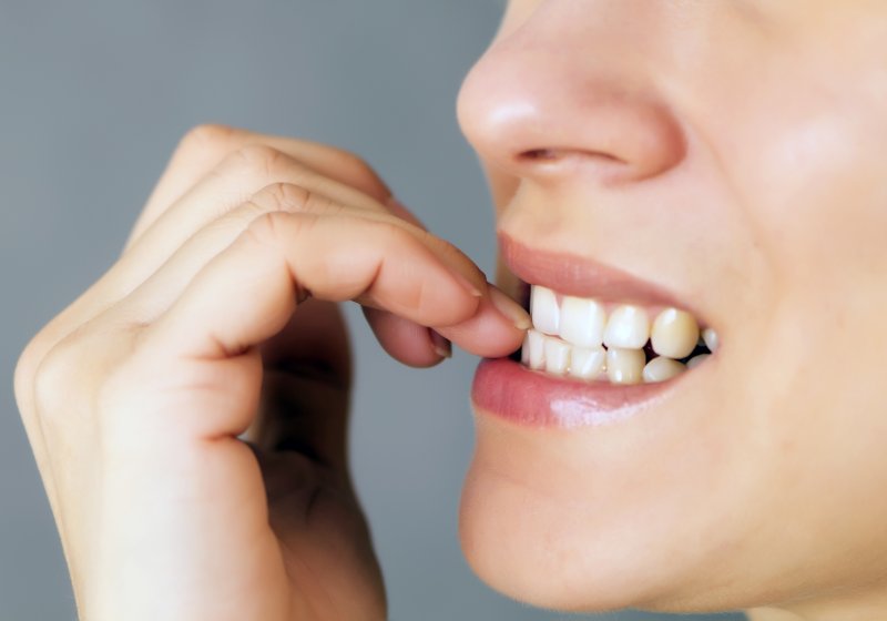 Closeup of woman biting her nails