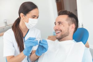 Dentist answering male patient's Invisalign questions during consultation