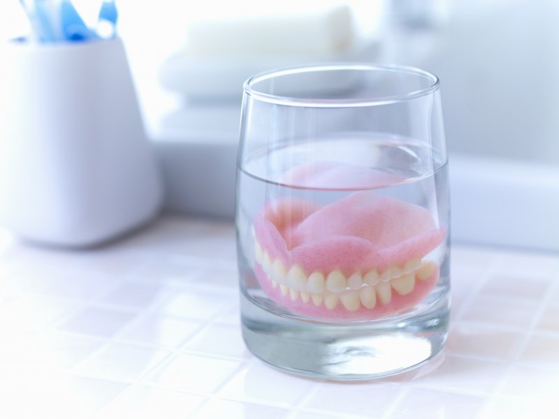 Dentures soaking in glass