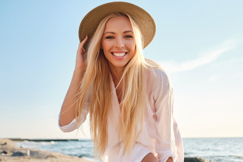 Woman on a beach with brilliant smile