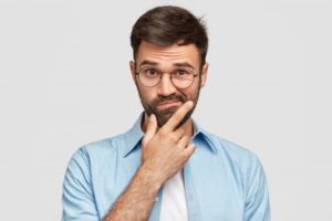 Man wondering about sedation dentistry in Torrance on gray background