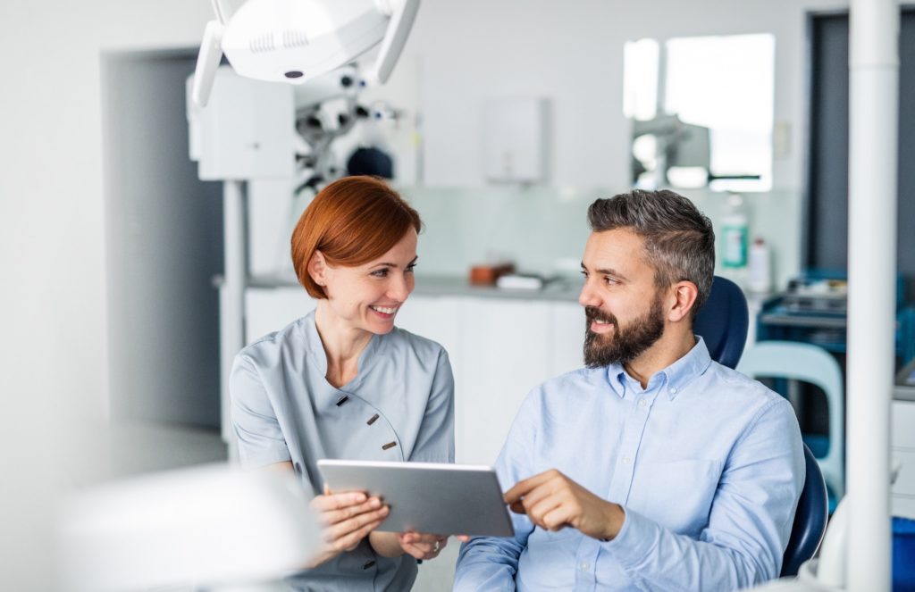 Dentist and patient reviewing dental insurance information