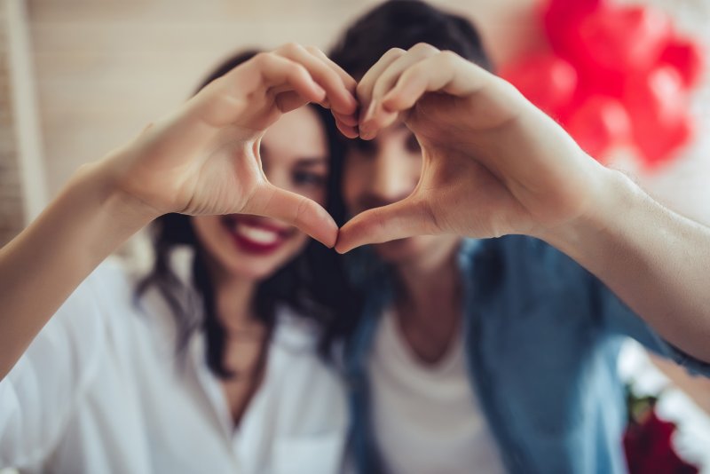 couple making heart with their hands