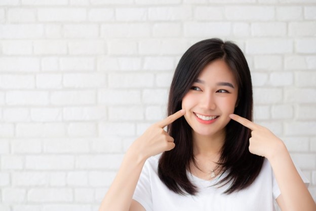 Woman pointing at smile.