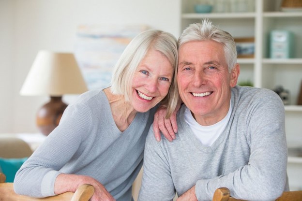 Older couple smiling.