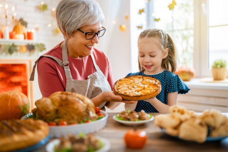 Grandma and granddaughter holding pie