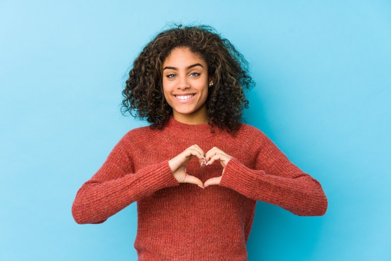 woman making a heart with her hands