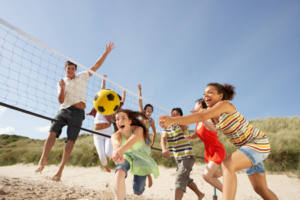 a group of people playing on a beach