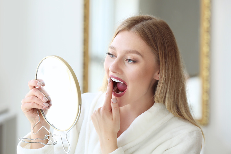 Patient checking their dental bridge in the mirror