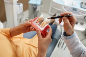 Patient learning how dental implants can benefit her