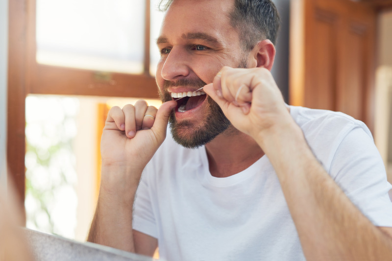 Patient smiling while flossing