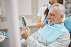 a patient chatting with their dentist and smiling